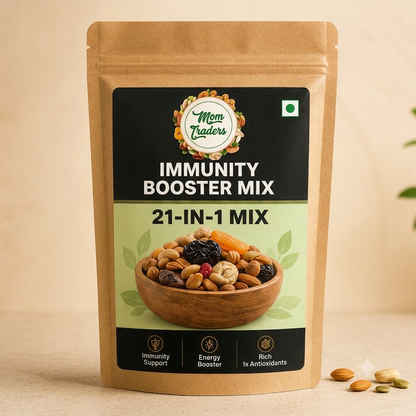 A stand-up pouch of Mom Traders Immunity Booster Mix 21-in-1 Mix, featuring a kraft paper bag with a black and light green label, set against a warm beige background with a few scattered almonds in the foreground.